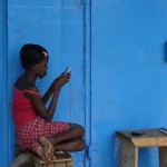 Girl with cellphone by IICD Girl with cellphone by IICD